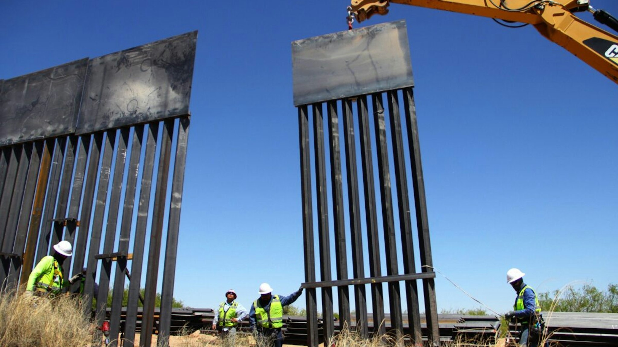 Workers replace an old section of the wall between the US and Mexico following orders by US President Donald Trump, in Santa Teresa, New Mexico State, US, close to Ciudad Juarez in Mexico's Chihuahua State, on April 23, 2018.
