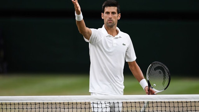 Serbia's Novak Djokovic gestures as he questions a line call during play against Spain's Rafael Nadal during their men's singles semi-final match on the eleventh day of the 2018 Wimbledon Championships at The All England Lawn Tennis Club in Wimbledon, southwest London, on July 13, 2018. (Photo by Glyn KIRK / AFP) / RESTRICTED TO EDITORIAL USE (Photo credit should read