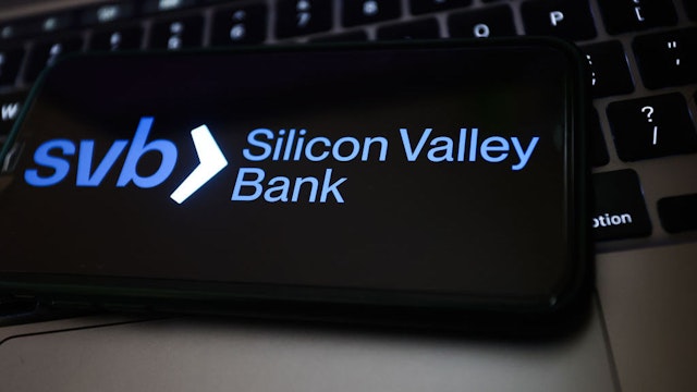 Valley Bank logo displayed on a phone screen and a laptop keyboard are seen in this illustration photo taken in Poland on March 14, 2023. (Photo by Jakub Porzycki/NurPhoto)