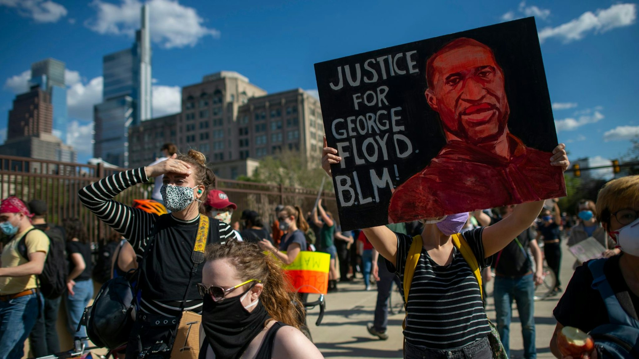 PHILADELPHIA, PA - JUNE 01: A protester holds a tribute poster to George Lloyd after a march through Center City on June 1, 2020 in Philadelphia, Pennsylvania. Demonstrations have erupted all across the country in response to George Floyd's death in Minneapolis, Minnesota while in police custody a week ago.