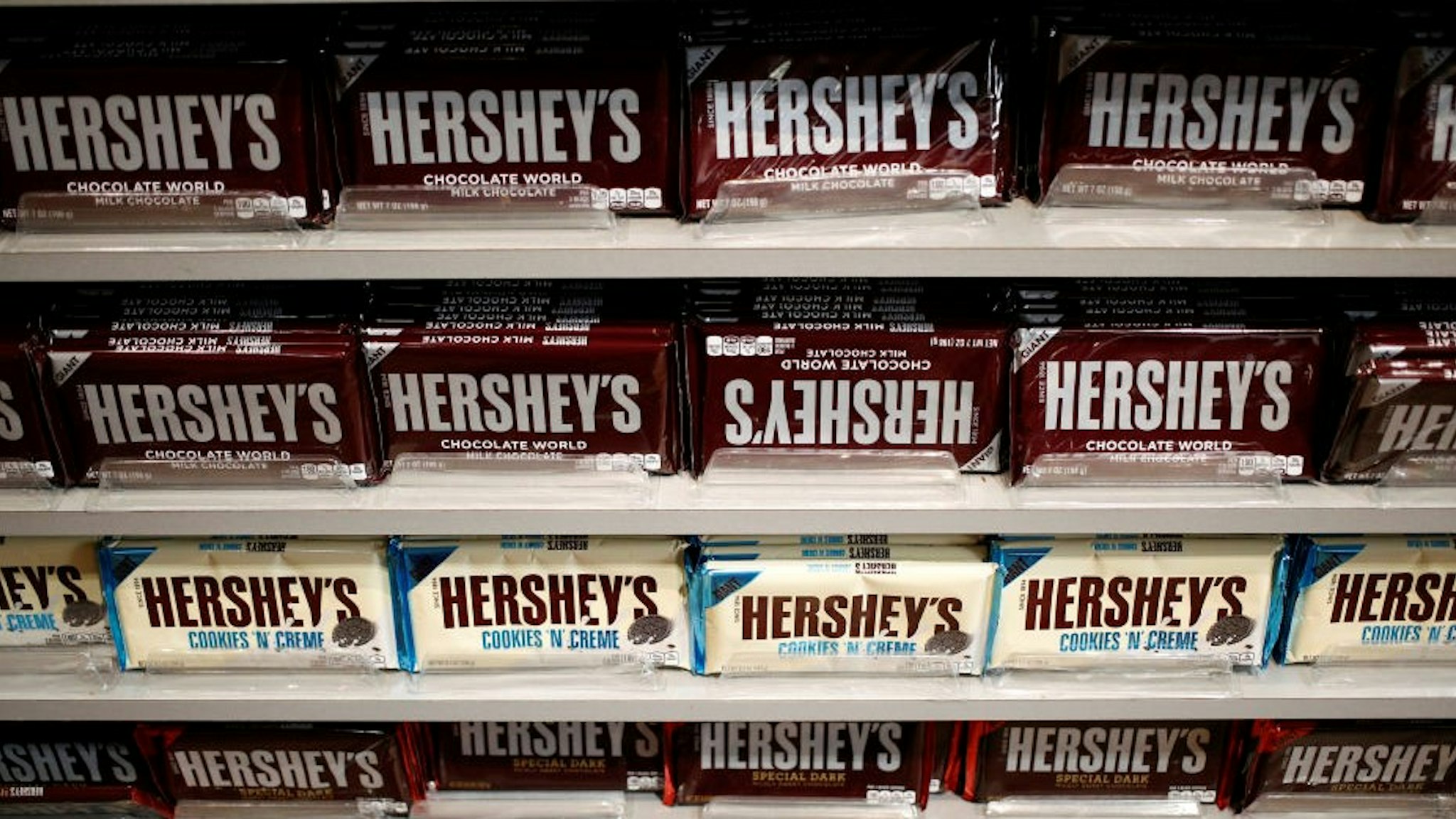 Hershey Co. candy bars are displayed for sale inside of the company's Chocolate World visitor center in Hershey, Pennsylvania, U.S., on Tuesday, Nov. 28, 2017. Hershey launched its first new bar brand, "Hershey's Gold," in 22 years nationwide on Friday. Photographer:
