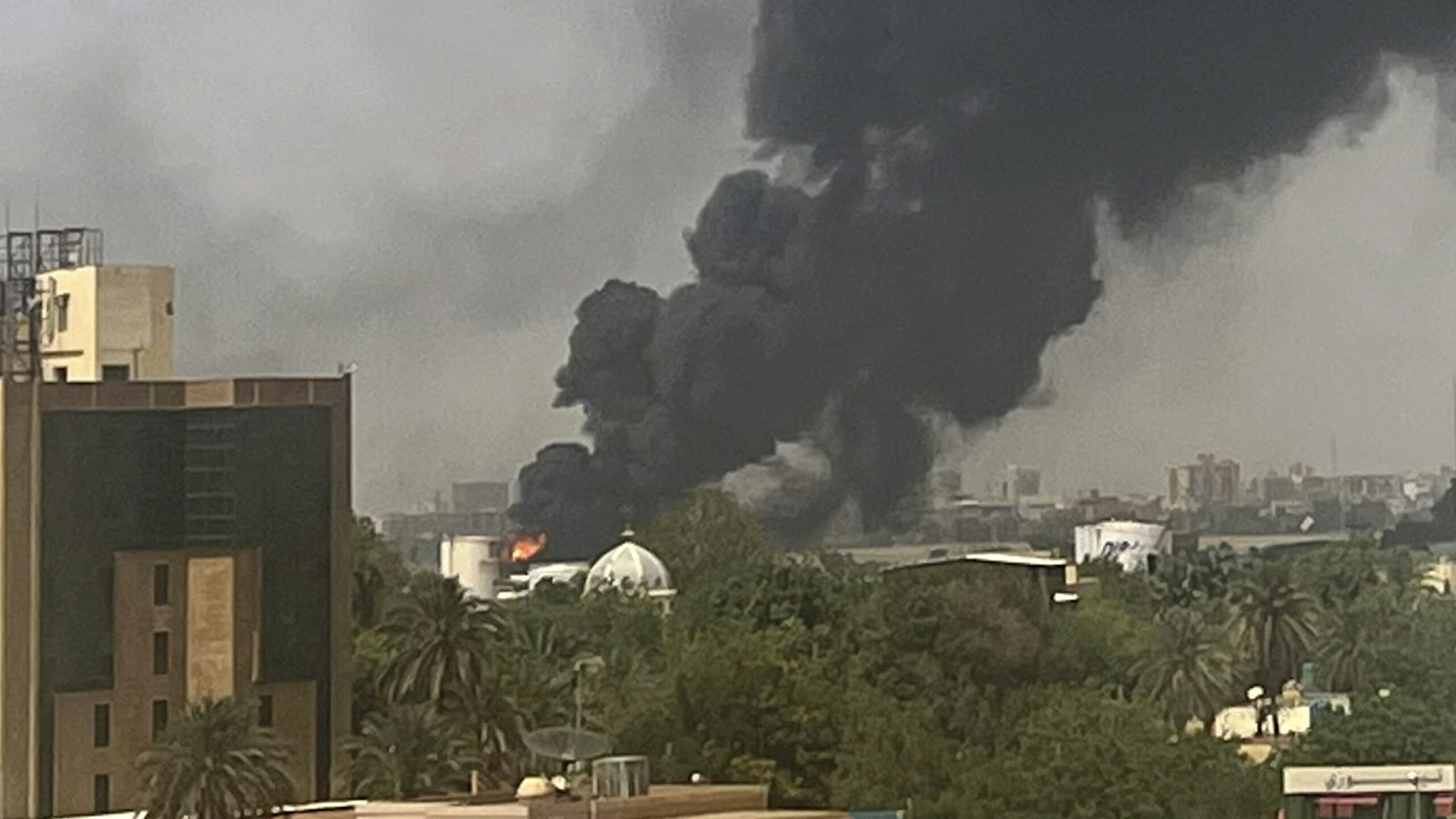 Smoke billows above residential buildings in Khartoum on April 16, 2023, as fighting in Sudan raged for a second day in battles between rival generals.