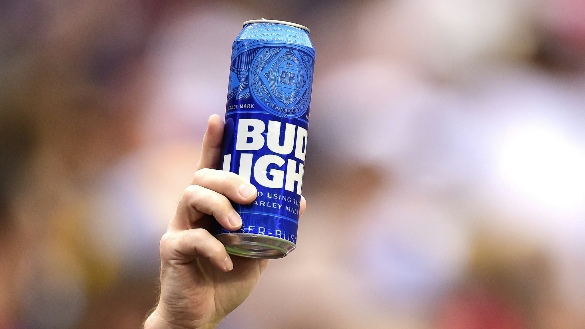LANDOVER, MD - OCTOBER 06: A fan holds up a can of Bud Light during a game between the New England Patriots and Washington Redskins at FedExField on October 6, 2019 in Landover, Maryland.