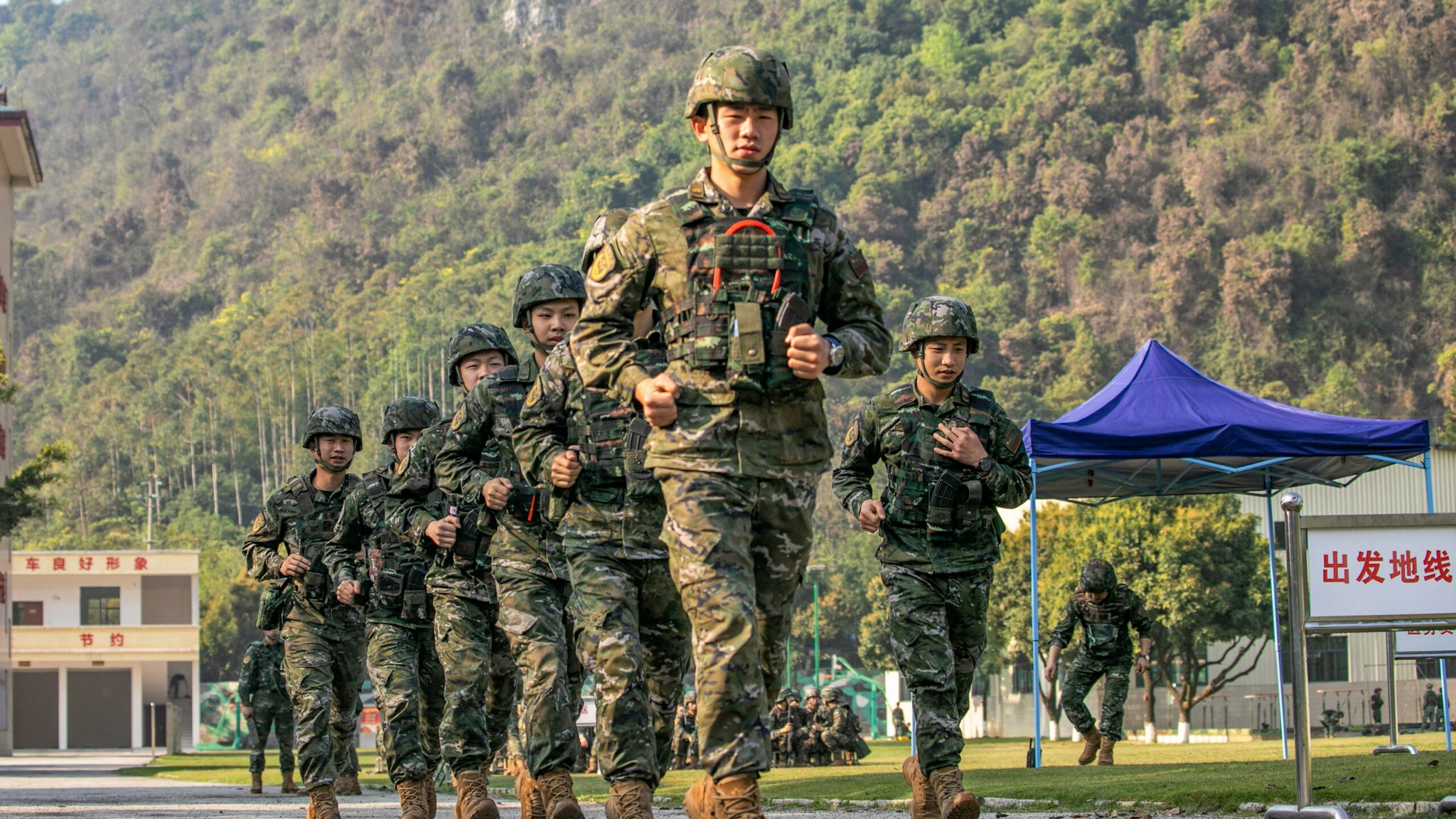 HECHI, CHINA - MARCH 22, 2023 - Security personnel make their way to a target trench in Hechi city, Guangxi Province, China, March 22, 2023.