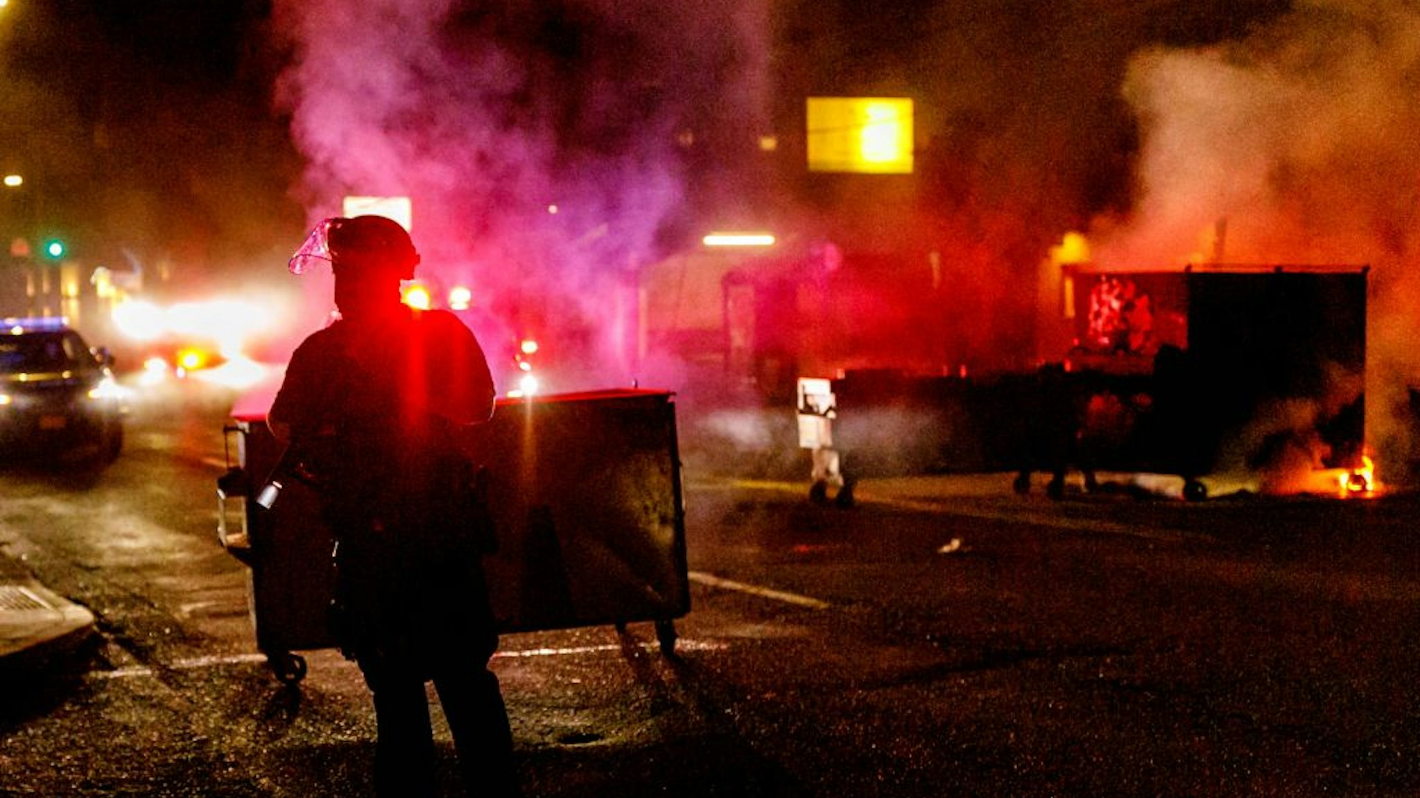 PORTLAND, OREGON, USA - AUGUST 28: About two hundred persons protesting police brutality spray graffiti and start fires at the Portland Police Union building, in Portland, Oregon, United States on August 28, 2020, the 93rd day of consecutive protests. Police declared a riot and arrested many people.