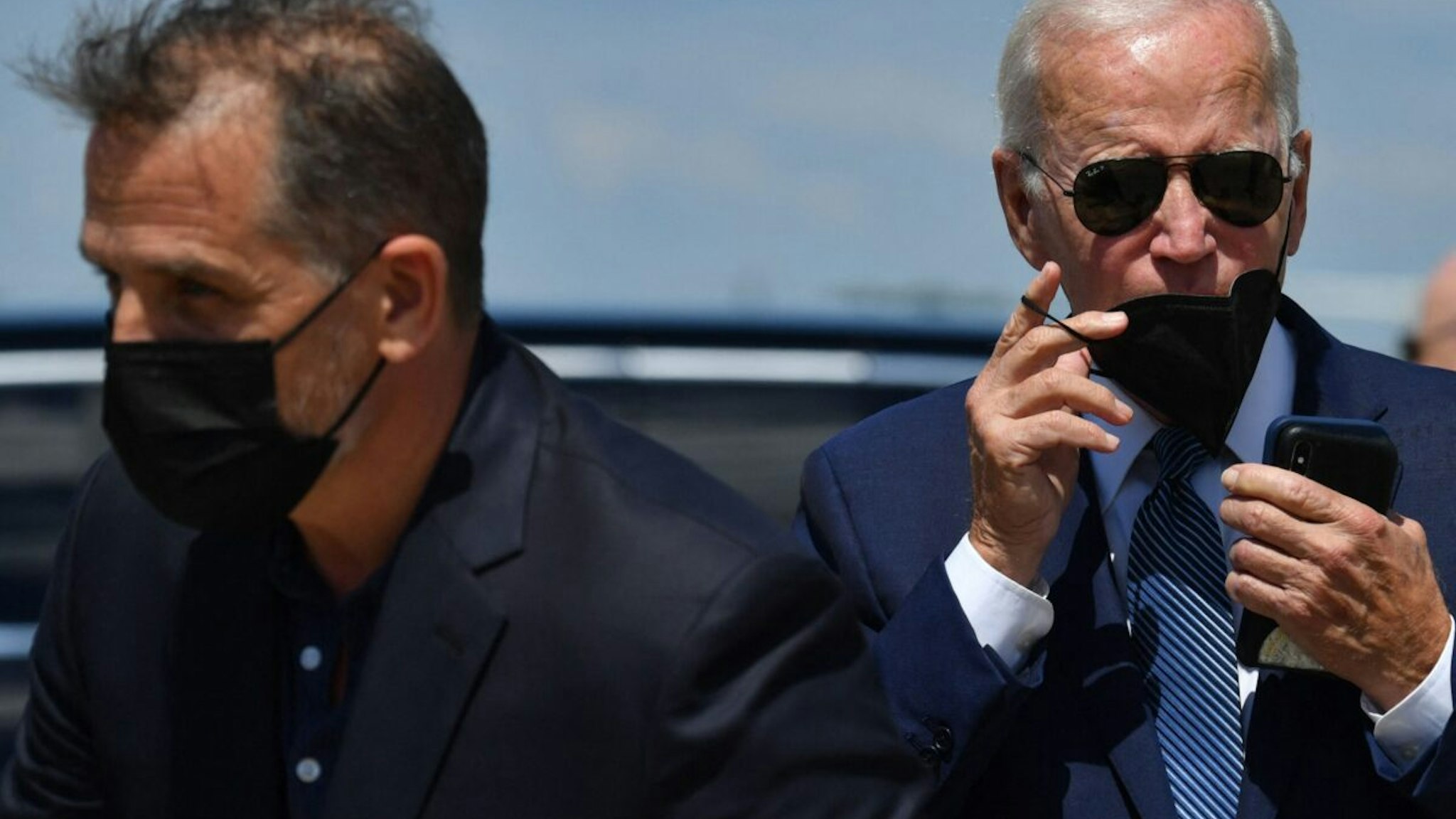 US President Joe Biden (R) and his son Hunter Biden walk to a vehicle after disembarking Air Force One upon arrival at Joint Base Andrews in Maryland on August 16, 2022, as they return from vacation in Kiawah Island, South Carolina.