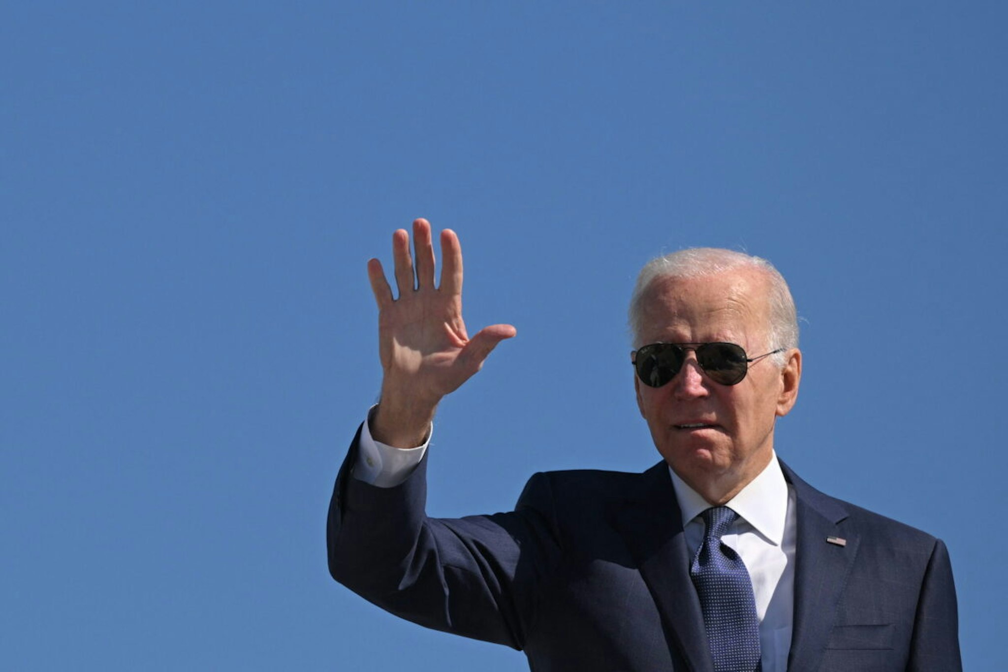 US President Joe Biden waves as he boards Air Force One before departing Joint Base Andrews in Maryland on October 7, 2022.