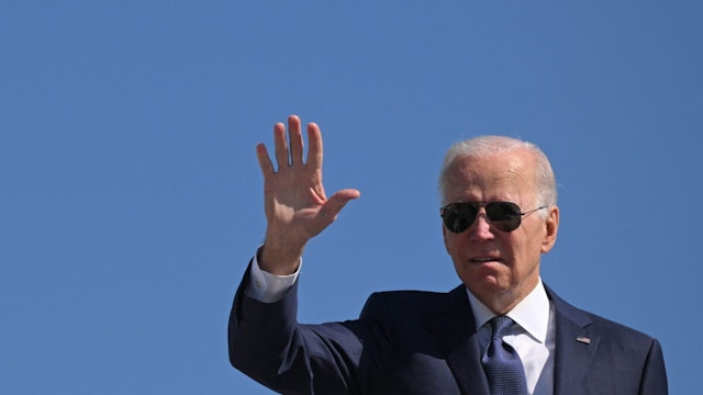 US President Joe Biden waves as he boards Air Force One before departing Joint Base Andrews in Maryland on October 7, 2022.