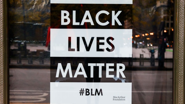 Black Lives Matter poster is seen in a window of MacArthur Foundation in Chicago, Illinois, United States, on October 18, 2022.