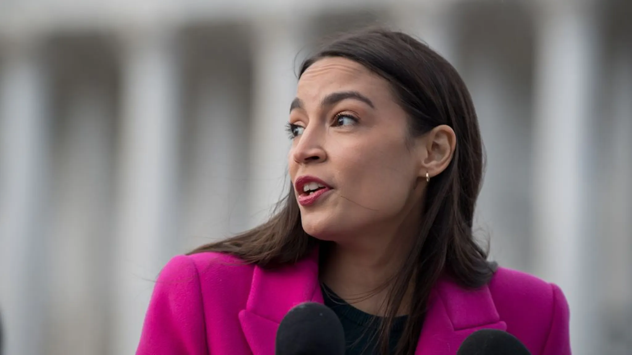 Democratic Lawmakers Hold News Conference On Border Policies Representative Alexandria Ocasio-Cortez, a Democrat from New York, speaks during a news conference outside the US Capitol in Washington, DC, US, on Thursday, Jan. 26, 2023. The number of asylum seekers crossing the southern US border has surged in recent months as the Biden administration committed to increase funding available to cities receiving migrants and to expand coordination. Photographer: Mary F. Calvert/Bloomberg via Getty Images