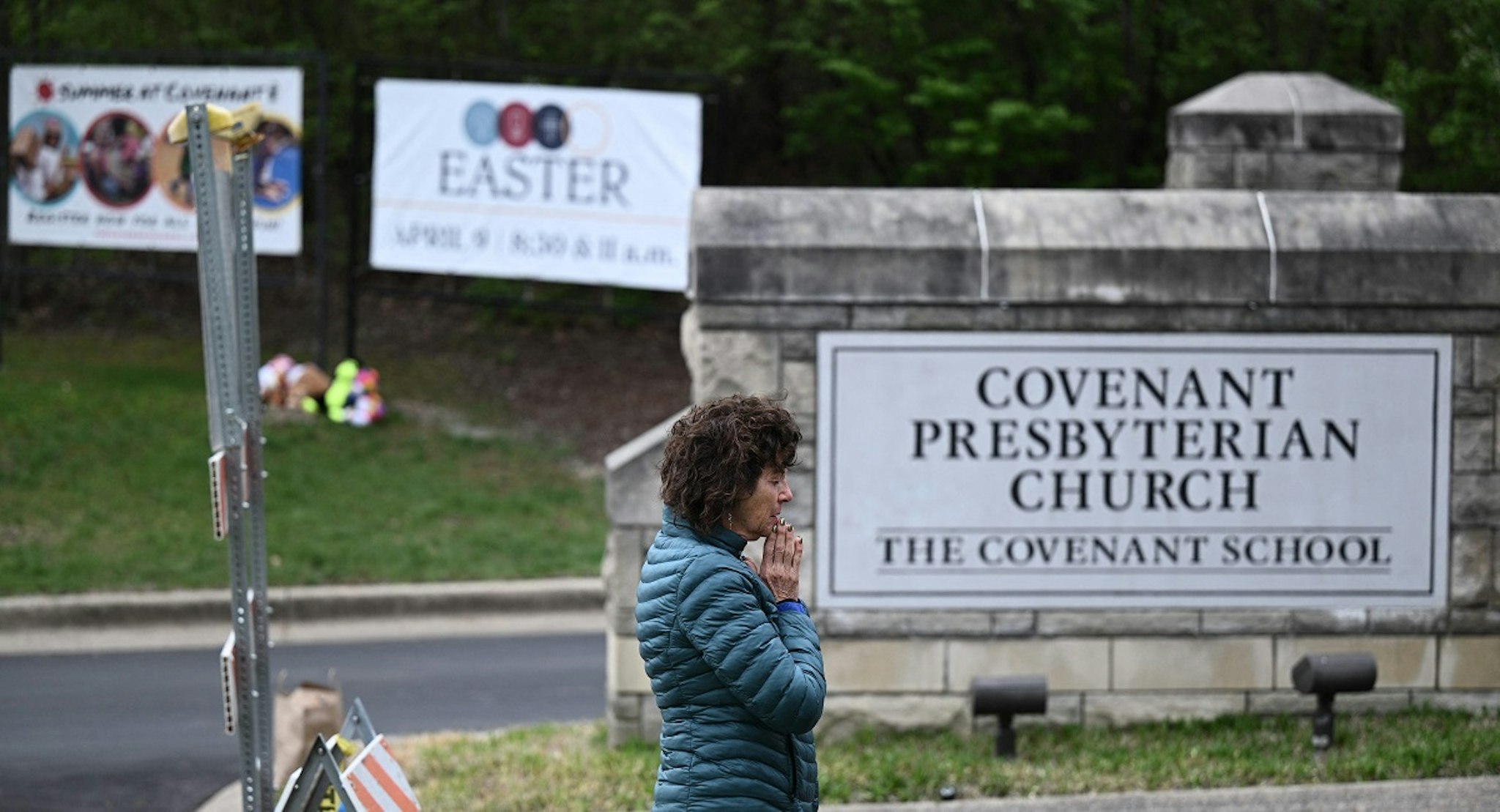Robin Wolfenden prays at a makeshift memorial for victims outside the Covenant School building at the Covenant Presbyterian Church following a shooting, in Nashville, Tennessee, on March 28, 2023.