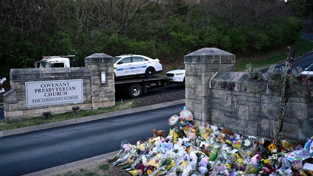 Police cars damaged during a shooting are removed from the Covenant School campus, in Nashville, Tennessee, March 28, 2023. - A heavily armed former student killed three young children and three staff in what appeared to be a carefully planned attack at a private elementary school in Nashville on Monday, before being shot dead by police. Chief of Police John Drake named the suspect as Audrey Hale, 28, who the officer later said identified as transgender.