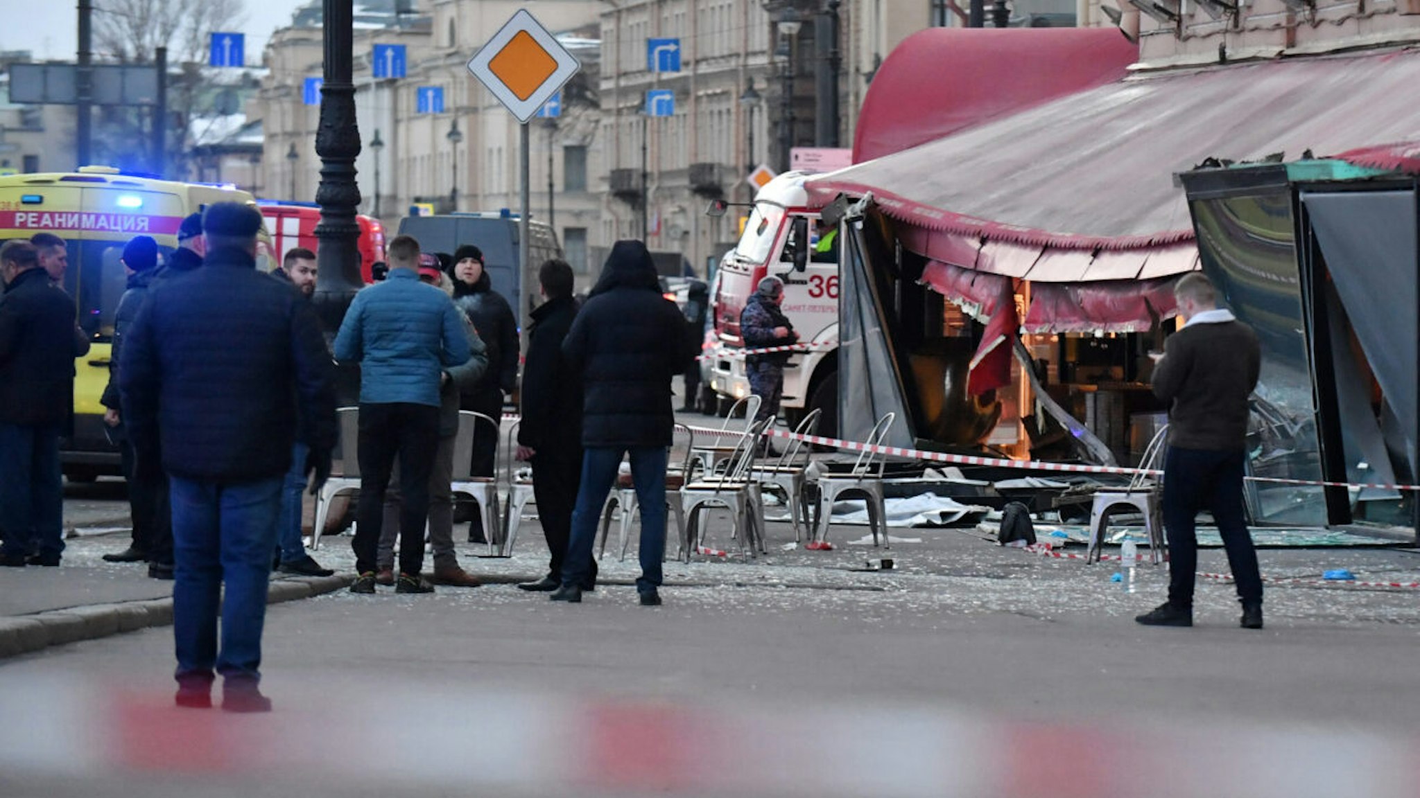 Russian police investigators inspect a damaged 'Street bar' cafe in a blast in Saint Petersburg on April 2, 2023. - A leading Russian military blogger was killed on April 2, 2023 in an explosion at a cafe in Russia's second-largest city of Saint Petersburg, the interior ministry said.