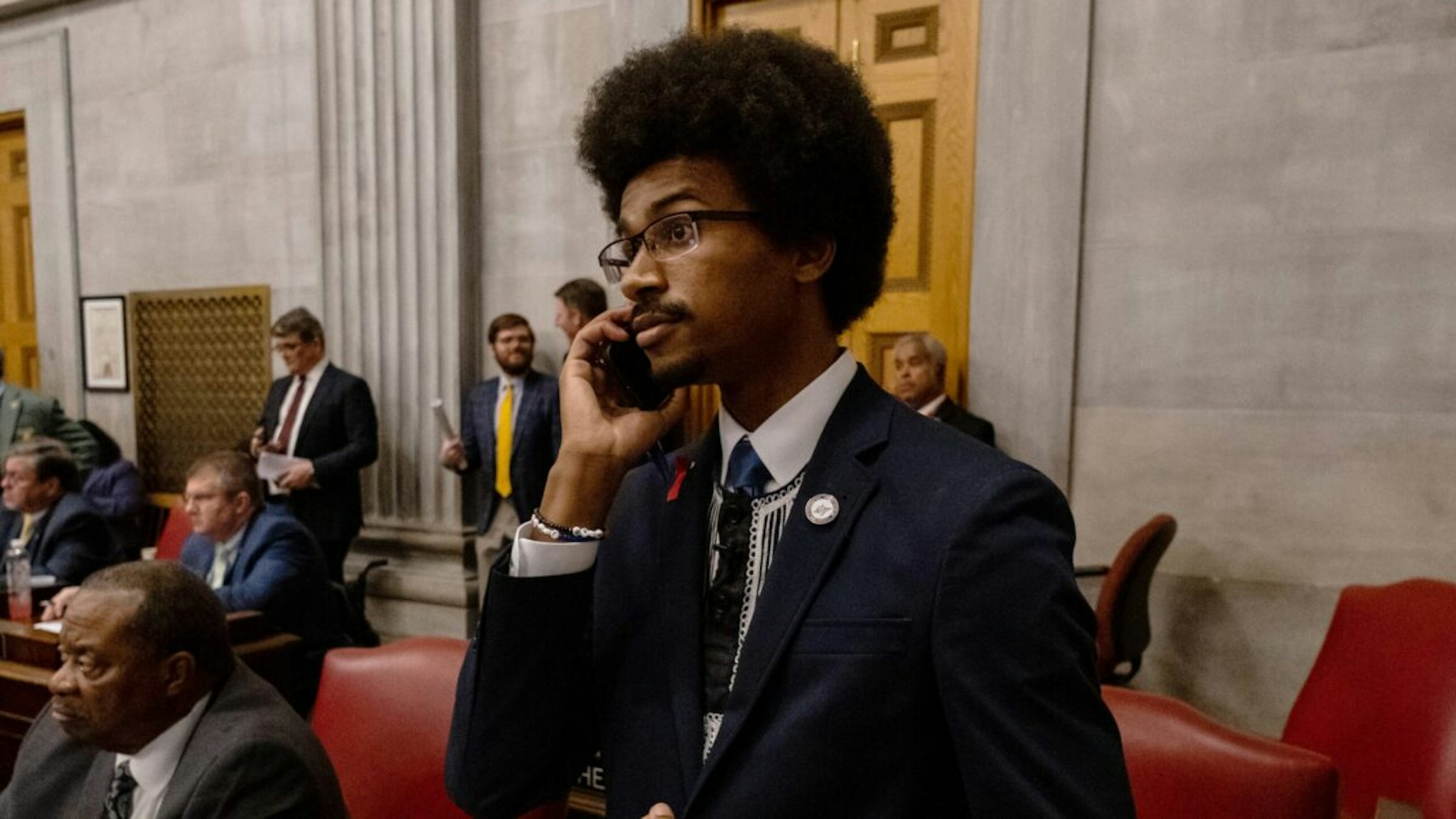 NASHVILLE, TN - APRIL 06: Democratic state Rep. Justin Pearson of Memphis speaks on his phone while being expelled from the state Legislature on April 6, 2023 in Nashville, Tennessee.