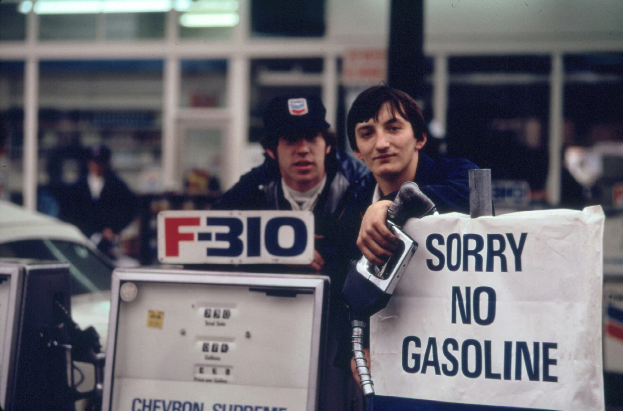 Gas Station Attendants Peer over Their 'Out of Gas' Sign in Portland, on Day before the State's Requested Saturday Closure of Gasoline Stations 11/1973.