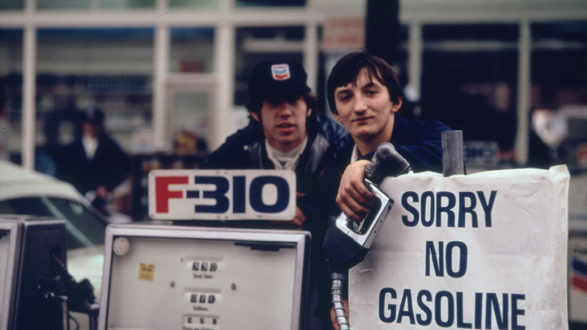 Gas Station Attendants Peer over Their 'Out of Gas' Sign in Portland, on Day before the State's Requested Saturday Closure of Gasoline Stations 11/1973.