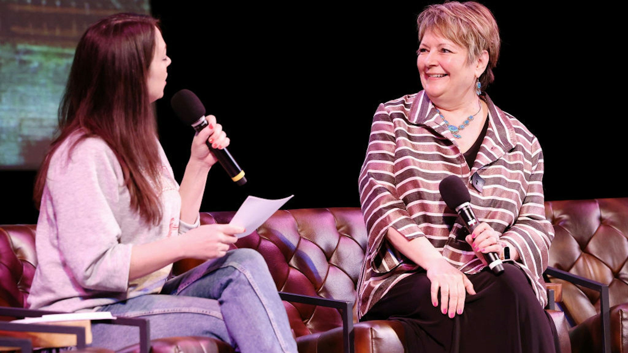 Erin Ryan and Judge Janet Protasiewicz speak onstage during the live taping of "Pod Save America," hosted by WisDems at the Barrymore Theater on March 18, 2023 in Madison, Wisconsin.