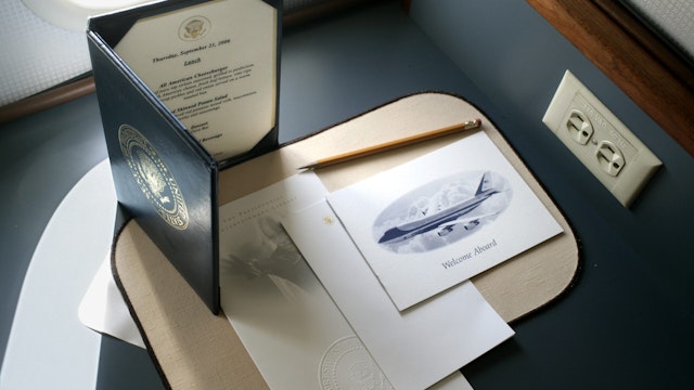 The lunch menu, Presidential entertainment offerings, and Air Force One stationary sit on a desk aboard Air Force One, before take off at Andrews Air Force, MD, September 21, 2006. On the menu for President Bush's trip to Tampa, Florida was an "All American Cheeseburger, Red Skinned Potato Salad, Dove Bar, and Choice of Beverage".