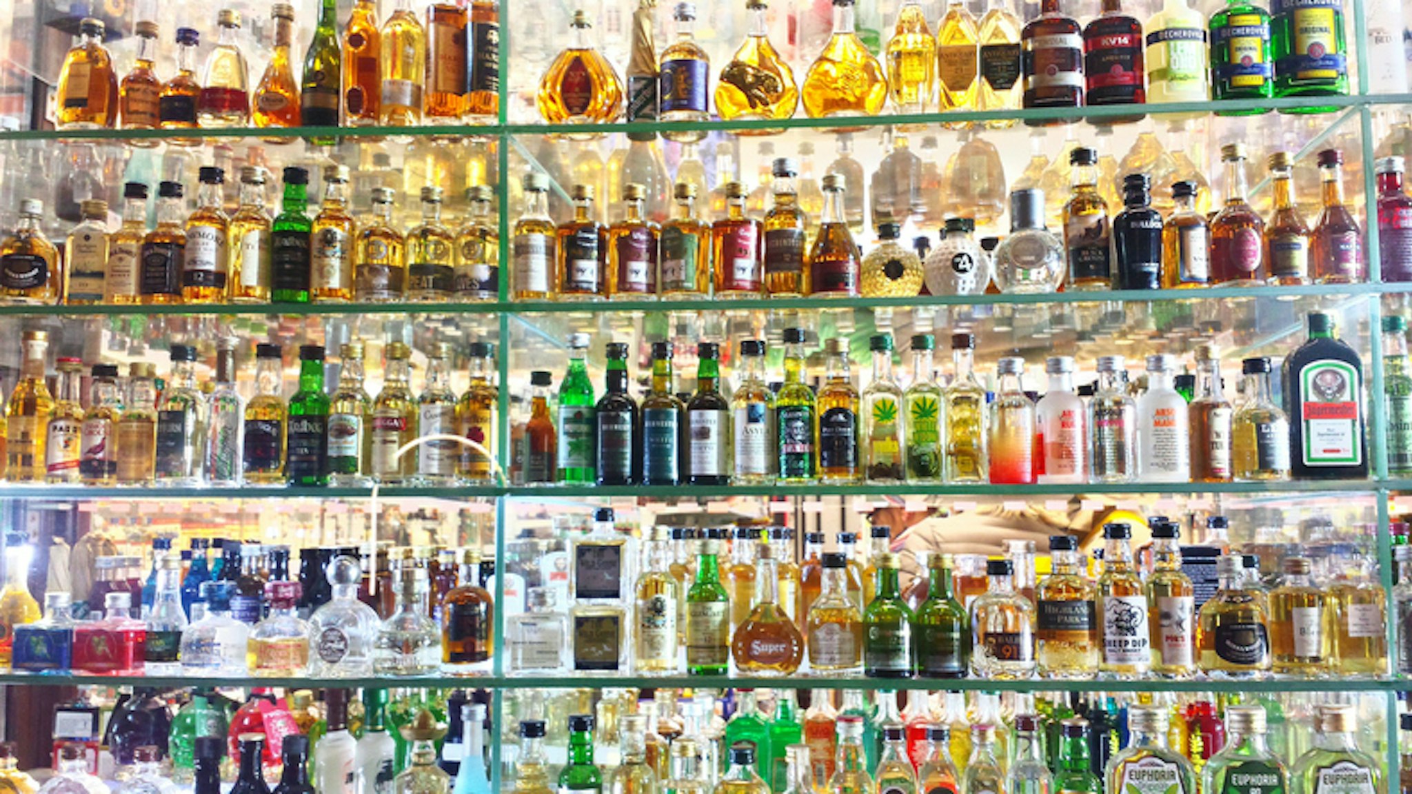 Full Frame Shot Of Alcohol Bottles In Shelf