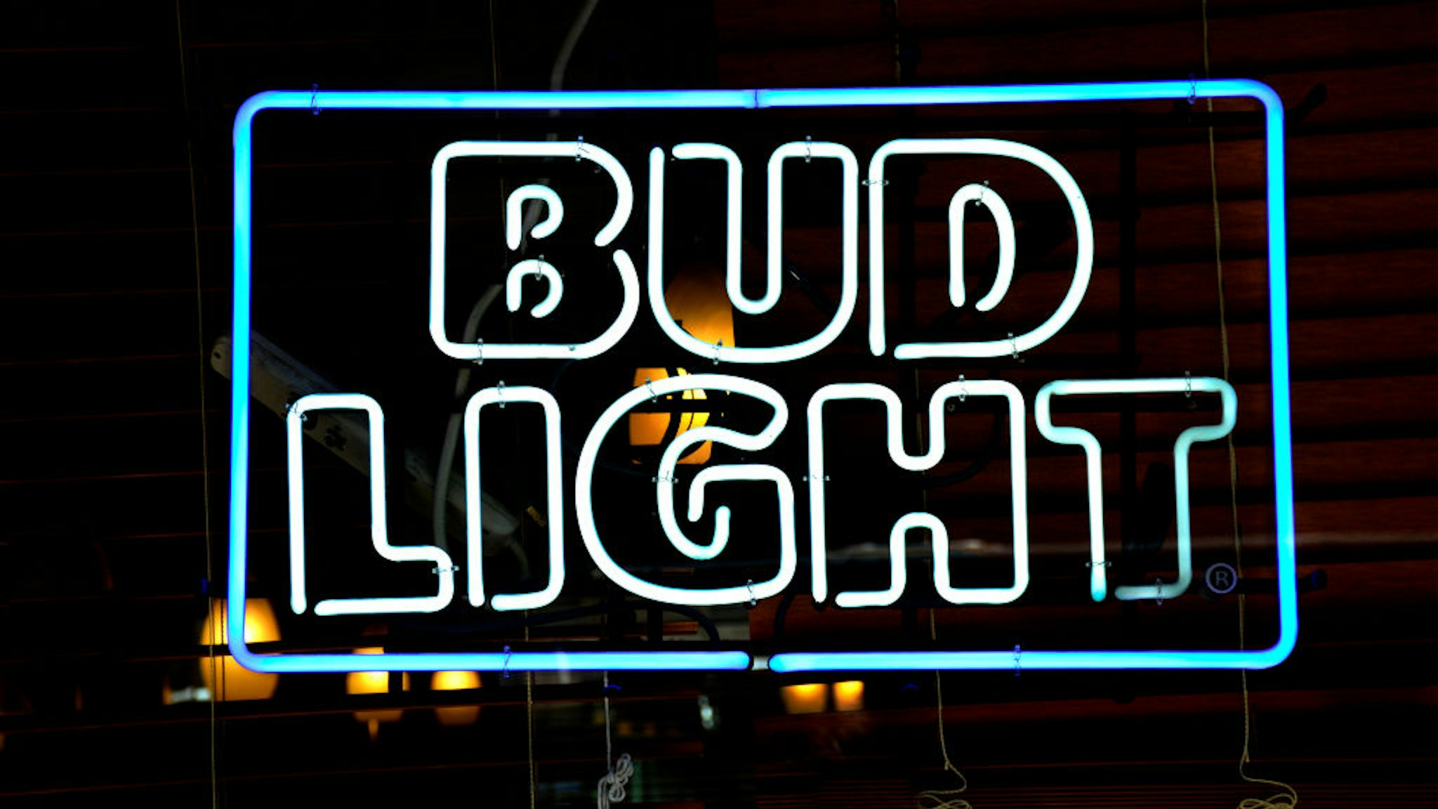 NEW YORK, NY - SEPTEMBER 23, 2017: A Bud Light neon sign hangs in the window of a store in New York, New York. (Photo by Robert Alexander/Getty Images)
