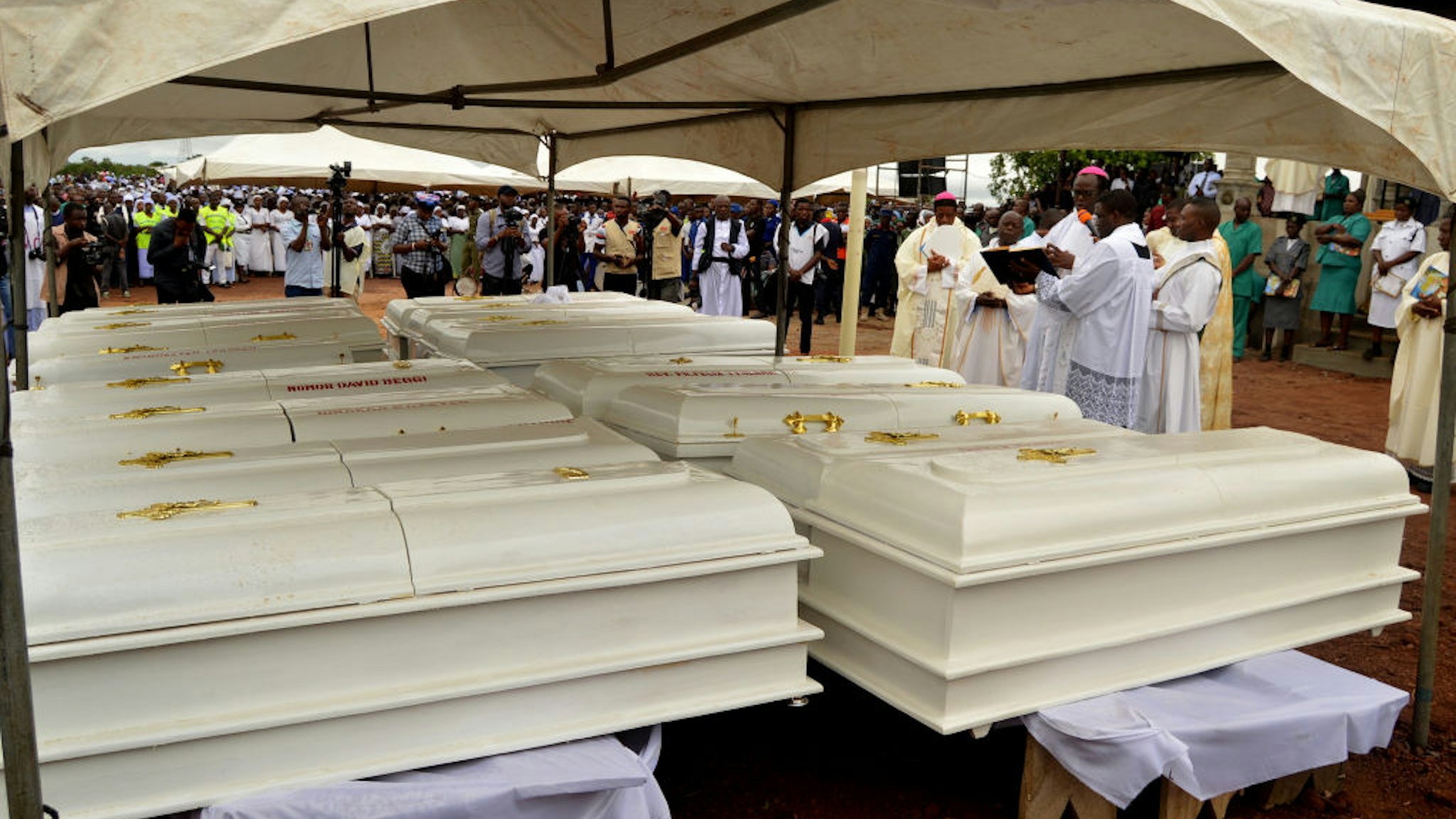 Coffins of 17 worshippers and two priests, who were allegedly killed by Fulani herdsmen stand during a funeral service at Ayati-Ikpayongo in Gwer East district of Benue State, north-central Nigeria on May 22, 2018. - Two Nigerian priests and 17 worshippers have been buried, nearly a month after an attack on their church, as Catholics took to the streets calling for an end to a spiral of violence. White coffins containing the bodies of the clergymen and the members of their congregation were laid to rest in central Benue state, which has been hit by a wave of deadly unrest.