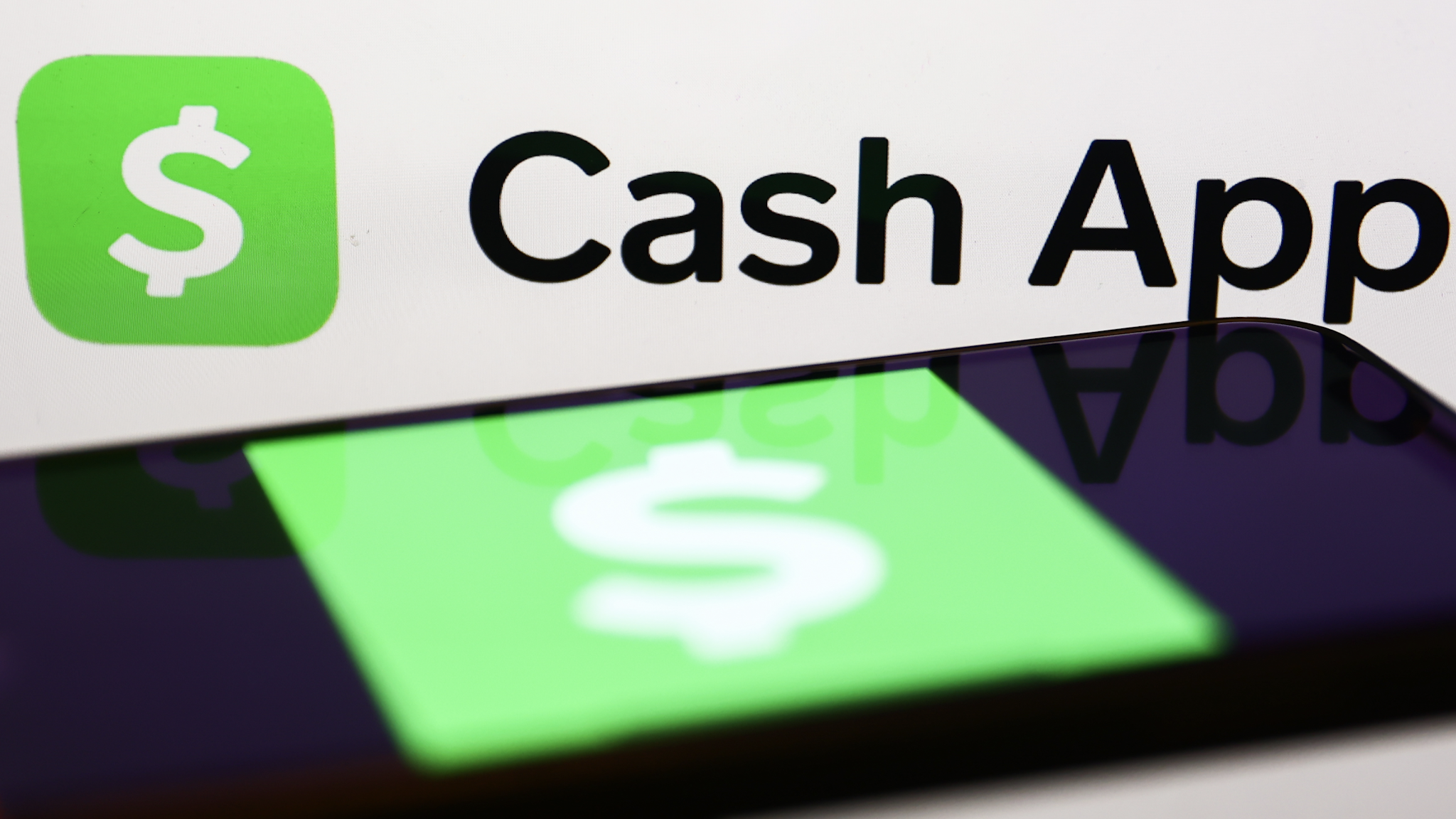 Cash App logo displayed on a laptop screen and Cash App icon displayed on a phone screen are seen in this illustration photo taken in Krakow, Poland on January 2, 2023.