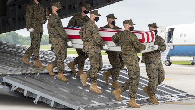 DOVER, DELAWARE - AUGUST 29: In this handout photo provided by the U.S. Air Force, a U.S. Marine Corps carry team transfers the remains of Marine Corps Lance Cpl. Jared M. Schmitz of St. Charles, Missouri, Aug. 29, 2021 at Dover Air Force Base, Delaware. Schmitz was assigned to 2nd Battalion, 1st Marine Regiment, 1st Marine Division, I Marine Expeditionary Force, Camp Pendleton, California.