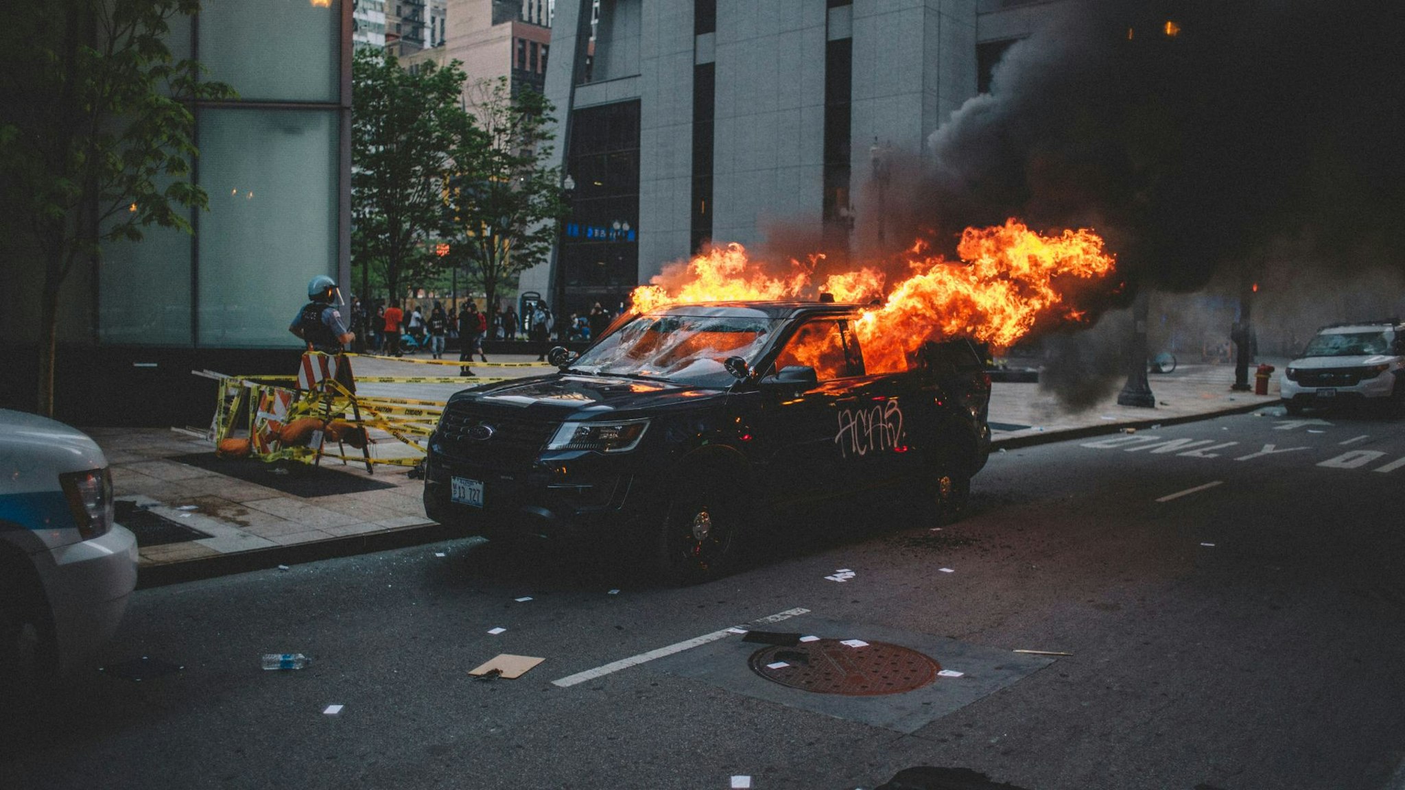 Protesters set fire to a police vehicle , on May 30, 2020 during a protest against the death of George Floyd, an unarmed black man who died while while being arrested and pinned to the ground by the knee of a Minneapolis police officer.