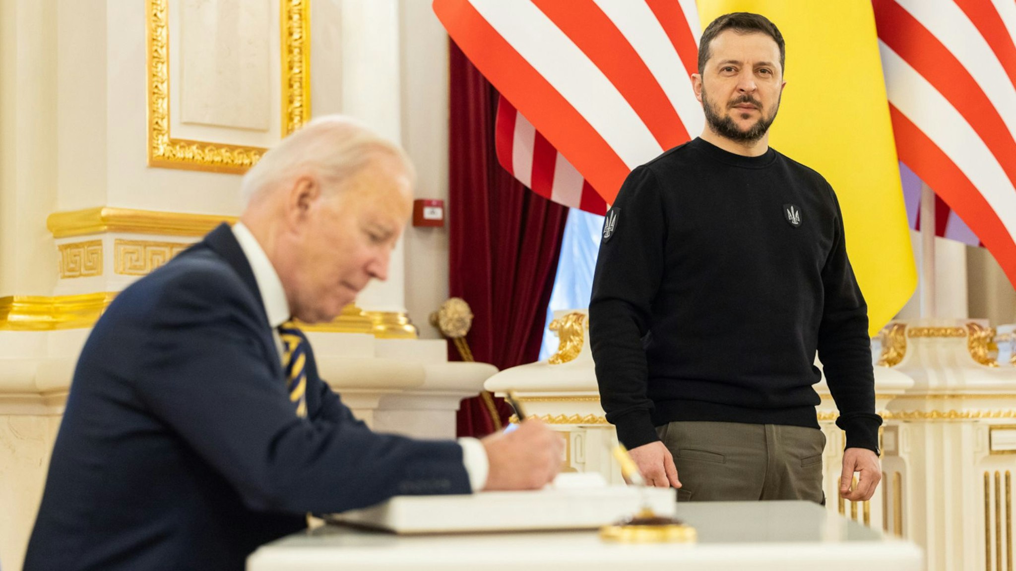 KYIV, UKRAINE - FEBRUARY 20: In this handout photo issued by the Ukrainian Presidential Press Office, U.S. President Joe Biden signs the guest book during a meeting with Ukrainian President Volodymyr Zelensky at the Ukrainian presidential palace on February 20, 2023 in Kyiv, Ukraine.