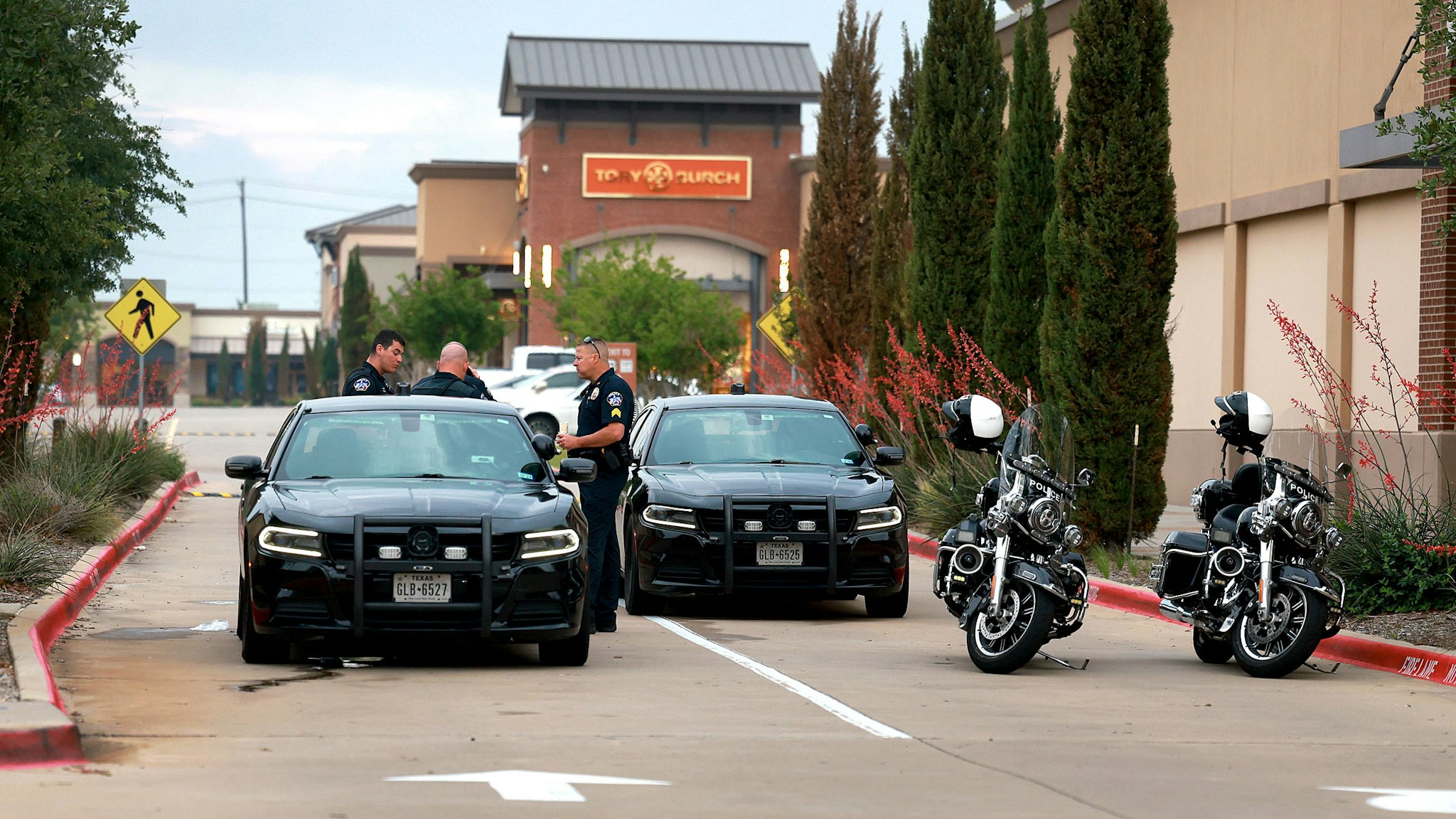 ALLEN, TEXAS - MAY 08: Police block an entrance to the Allen Premium Outlets mall after the mass shooting occurred on May 8, 2023 in Allen, Texas. On May 6th, a shooter opened fire at the outlet mall, killing eight people. The gunman was then killed by an Allen Police officer responding to an unrelated call.