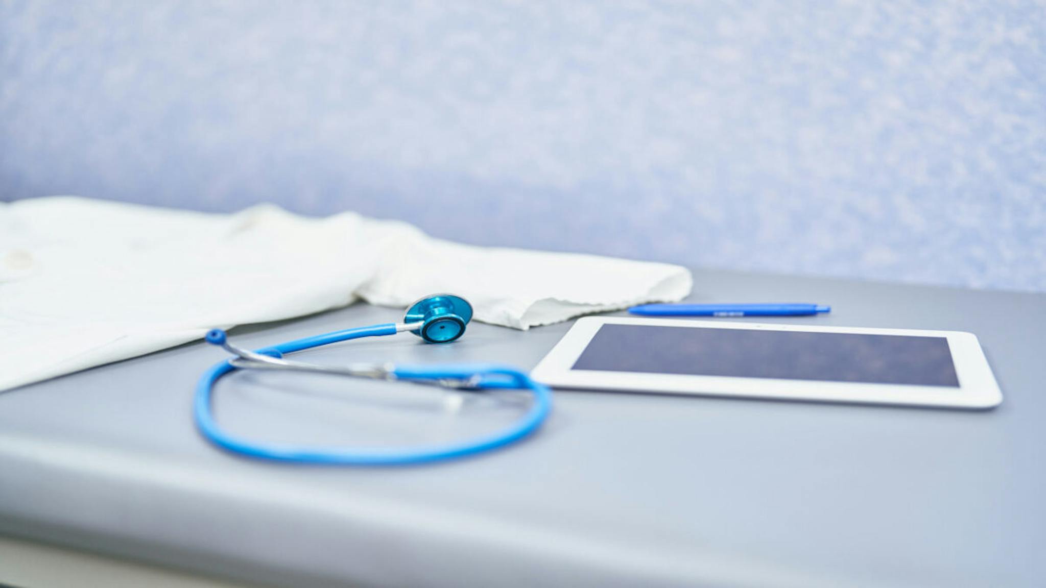 Empty stretcher in a hospital with a Stethoscope Empty stretcher in a hospital with a Stethoscope, tablet and pen, no people