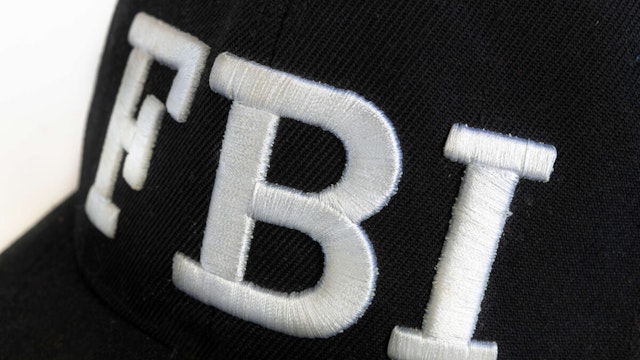 Close up of the FBI logo on a black cap. The text stands for Federal Bureau of Investigations.