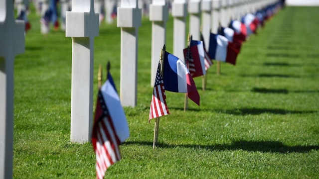 A picture taken at the Normandy American Cemetery and Memorial in Colleville-sur-Mer, Normandy, northwestern France, on June 6, 2019, shows French and US flags ahead of French-US ceremony as part of D-Day commemorations marking the 75th anniversary of the World War II Allied landings in Normandy. (Photo by Damien MEYER / AFP) (Photo by DAMIEN MEYER/AFP via Getty Images)