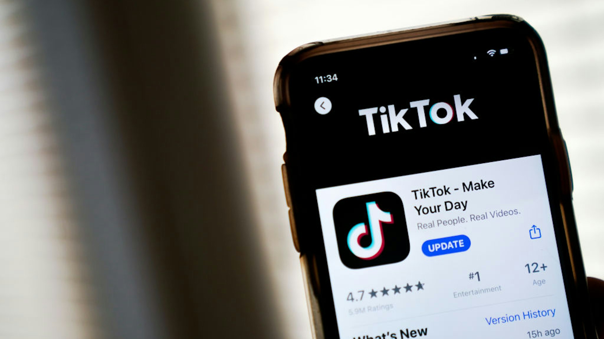 WASHINGTON, DC - AUGUST 07: In this photo illustration, the download page for the TikTok app is displayed on an Apple iPhone on August 7, 2020 in Washington, DC. On Thursday evening, President Donald Trump signed an executive order that bans any transactions between the parent company of TikTok, ByteDance, and U.S. citizens due to national security reasons. The president signed a separate executive order banning transactions with China-based tech company Tencent, which owns the app WeChat. Both orders are set to take effect in 45 days.