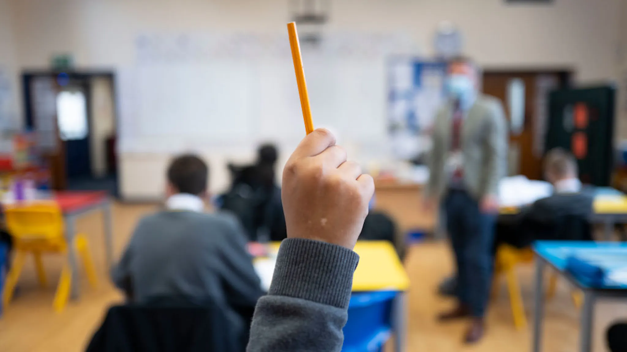 Pupils Return To The Classroom For The New School Year CARDIFF, WALES - SEPTEMBER 14: A pupil raises their hand during a lesson at Whitchurch High School on September 14, 2021 in Cardiff, Wales. All children aged 12 to 15 across the UK will be offered a dose of the Pfizer-BioNTech Covid-19 vaccine. Parental consent will be sought for the schools-based vaccination programme. (Photo by Matthew Horwood/Getty Images)