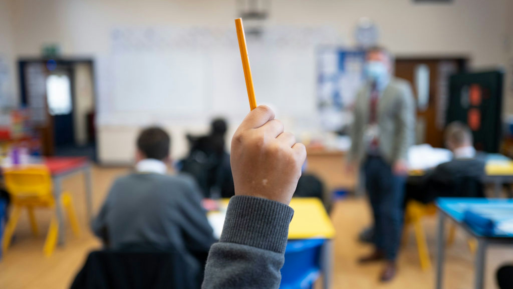 CARDIFF, WALES - SEPTEMBER 14: A pupil raises their hand during a lesson at Whitchurch High School on September 14, 2021 in Cardiff, Wales. All children aged 12 to 15 across the UK will be offered a dose of the Pfizer-BioNTech Covid-19 vaccine. Parental consent will be sought for the schools-based vaccination programme. (Photo by Matthew Horwood/Getty Images)