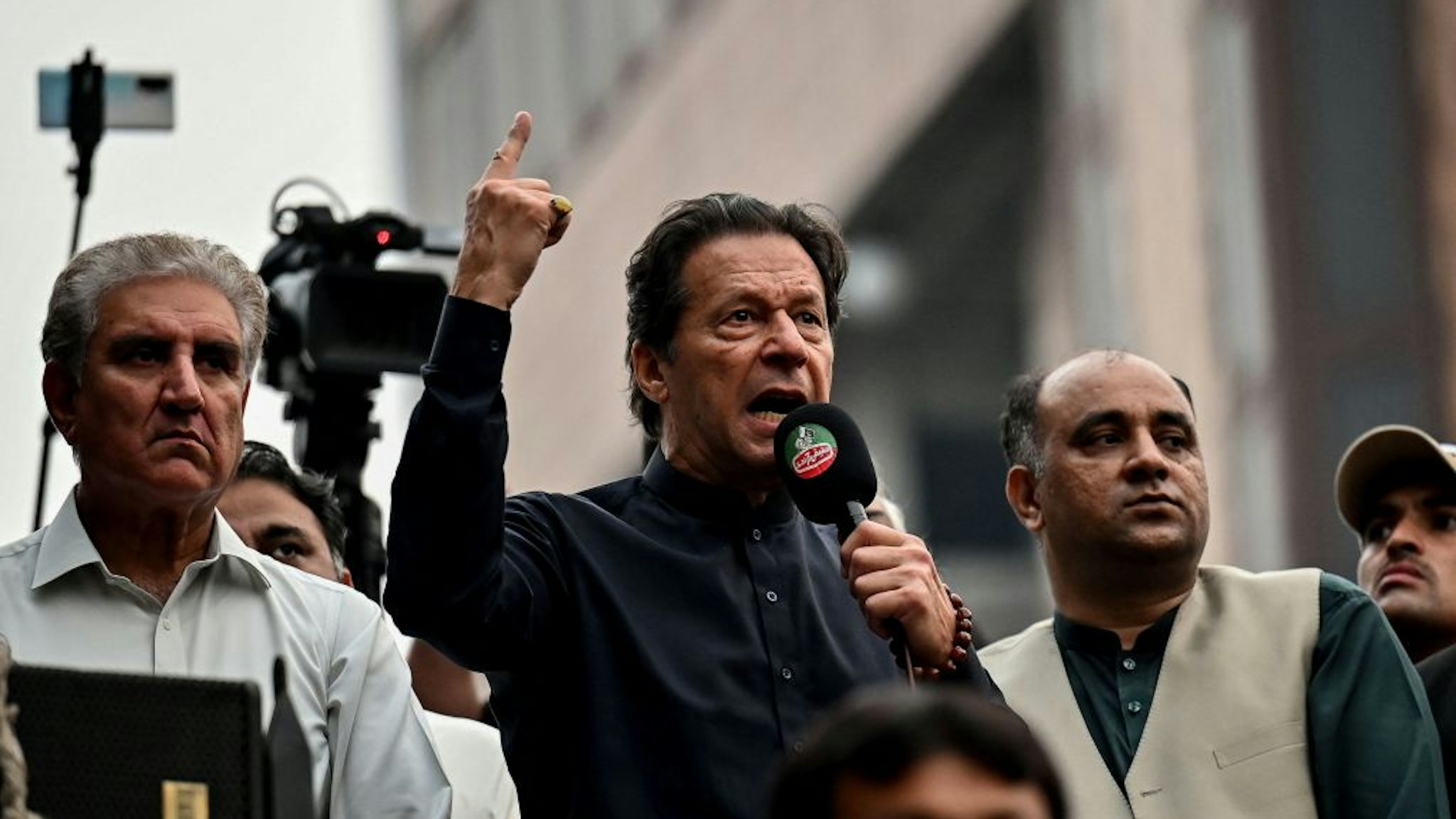 Pakistan's former prime minister Imran Khan (C) addresses his supporters during an anti-government march towards capital Islamabad, demanding early elections, in Gujranwala on November 1, 2022.