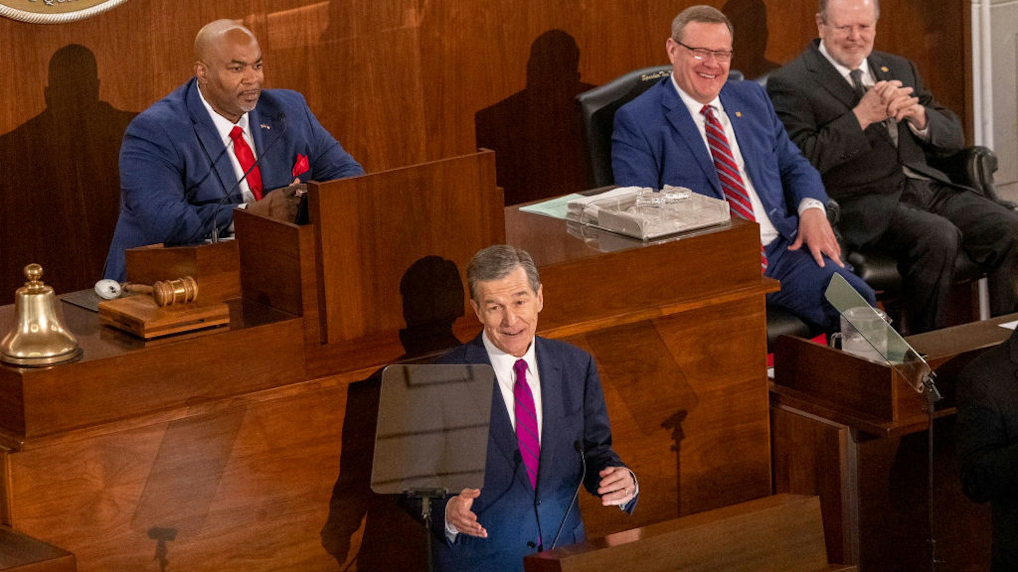 Gov. Roy Cooper delivers his State of the State address to a joint session of the N.C. General Assembly on Monday, March 6, 2023 as, from left, Lt. Gov. Mark Robinson, House Speaker Tim Moore and Senate Leader Phil Berger look on.