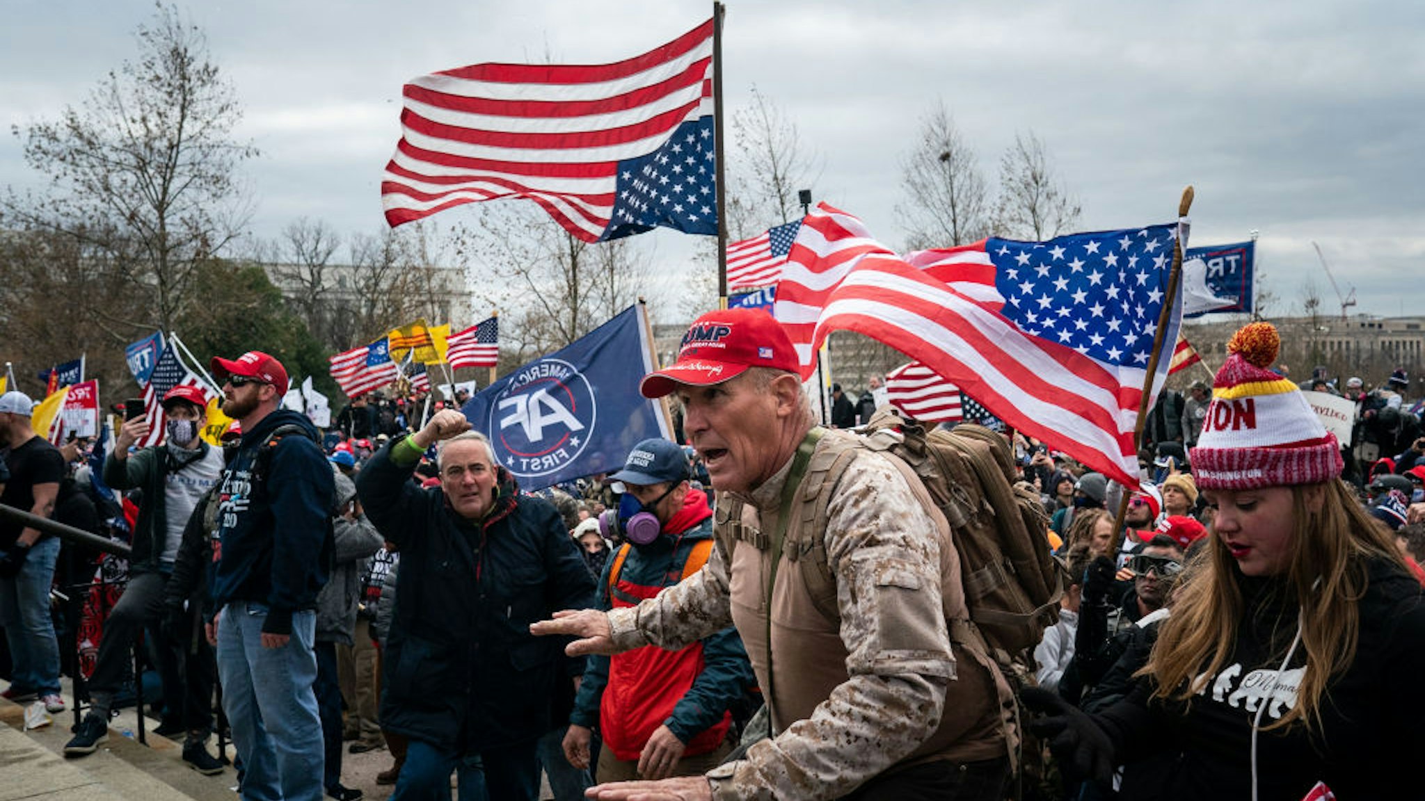 WASHINGTON, DC - JANUARY 06: Ray Epps, in the red Trump hat, center, gestures to a line of law enforcement officers, as people gather on the West Front of the U.S. Capitol on Wednesday, Jan. 6, 2021 in Washington, DC. January 6 marks the second day of Pro-Trump events fueled by President Donald Trump's continued claims of election fraud in an to overturn the results before Congress finalizes them in a joint session of the 117th Congress. (Kent Nishimura / Los Angeles Times via Getty Images)