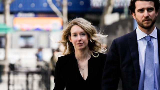 Former Theranos CEO Elizabeth Holmes alongside her boyfriend Billy Evans, walks back to her hotel following a hearing at the Robert E. Peckham U.S. Courthouse on March 17, 2023 in San Jose, California. Holmes appeared in court for a restitution hearing.