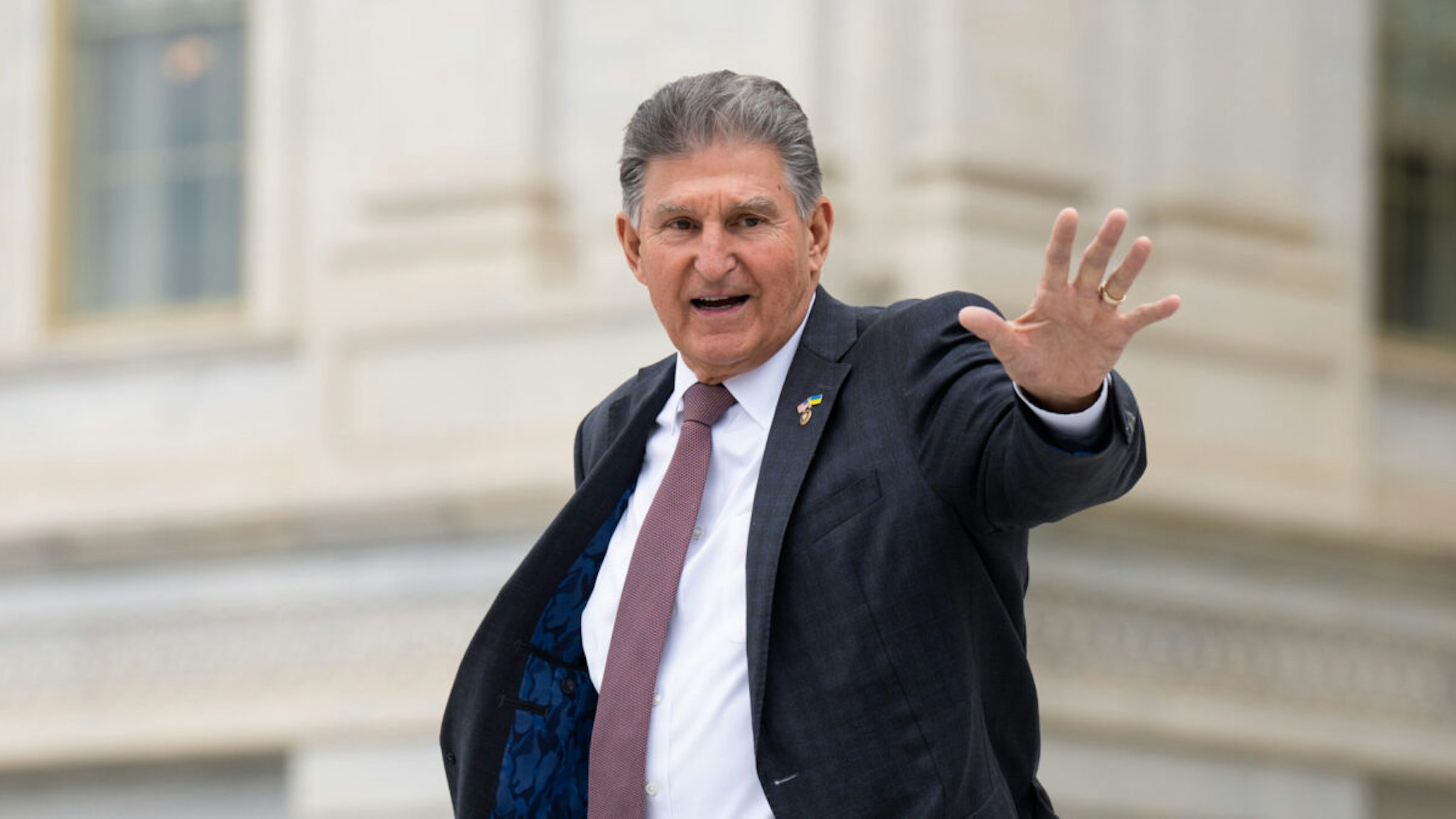 Sen. Joe Manchin, D-W. Va., waves to visitors on the Senate steps as he leaves the Capitol after the last vote of the week in Washington on Thurssday, May 4, 2023.
