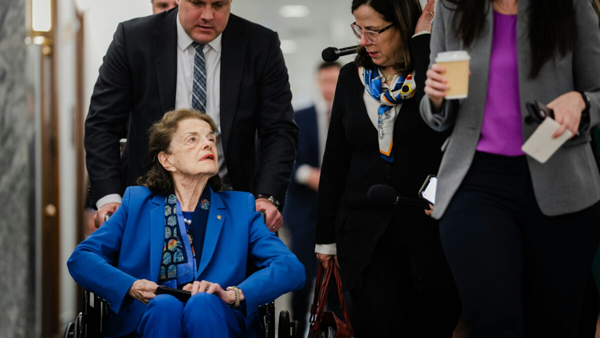 Sen. Dianne Feinstein (D-CA) talks with Nancy Corinne Prowda, second from right, daughter of Rep. Nancy Pelosi (D-CA) as Sen. Feinstein, surrounded by staff departs a Senate Judiciary Business Meeting at the Senate Dirksen Office Building on Capitol Hill on Thursday, May 18, 2023 in Washington, DC.