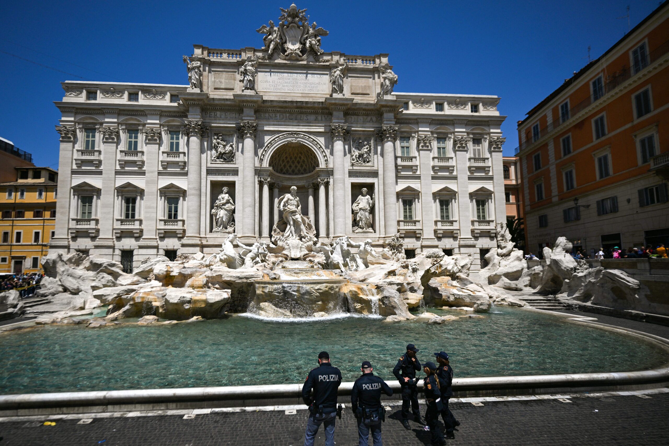Rome mayor blames climate activists for turning Trevi Fountain water black with charcoal, causing environmental damage.