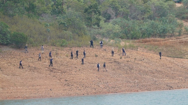 Personnel at Barragem do Arade reservoir, in the Algave, Portugal, as searches begin as part of the investigation into the disappearance of Madeleine McCann.