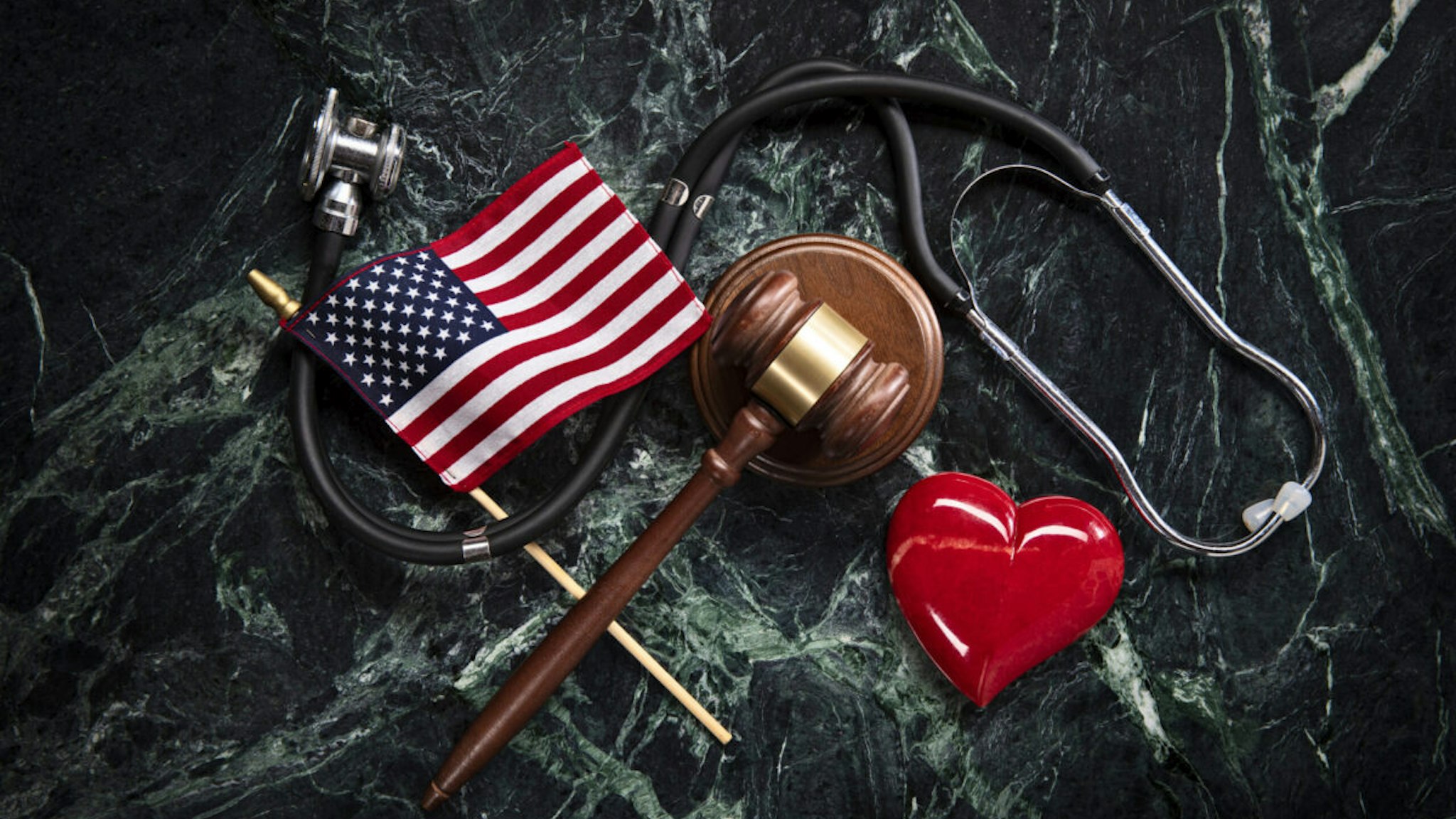 Health Care and Legal Concept with Stethoscope on Green Marble Background