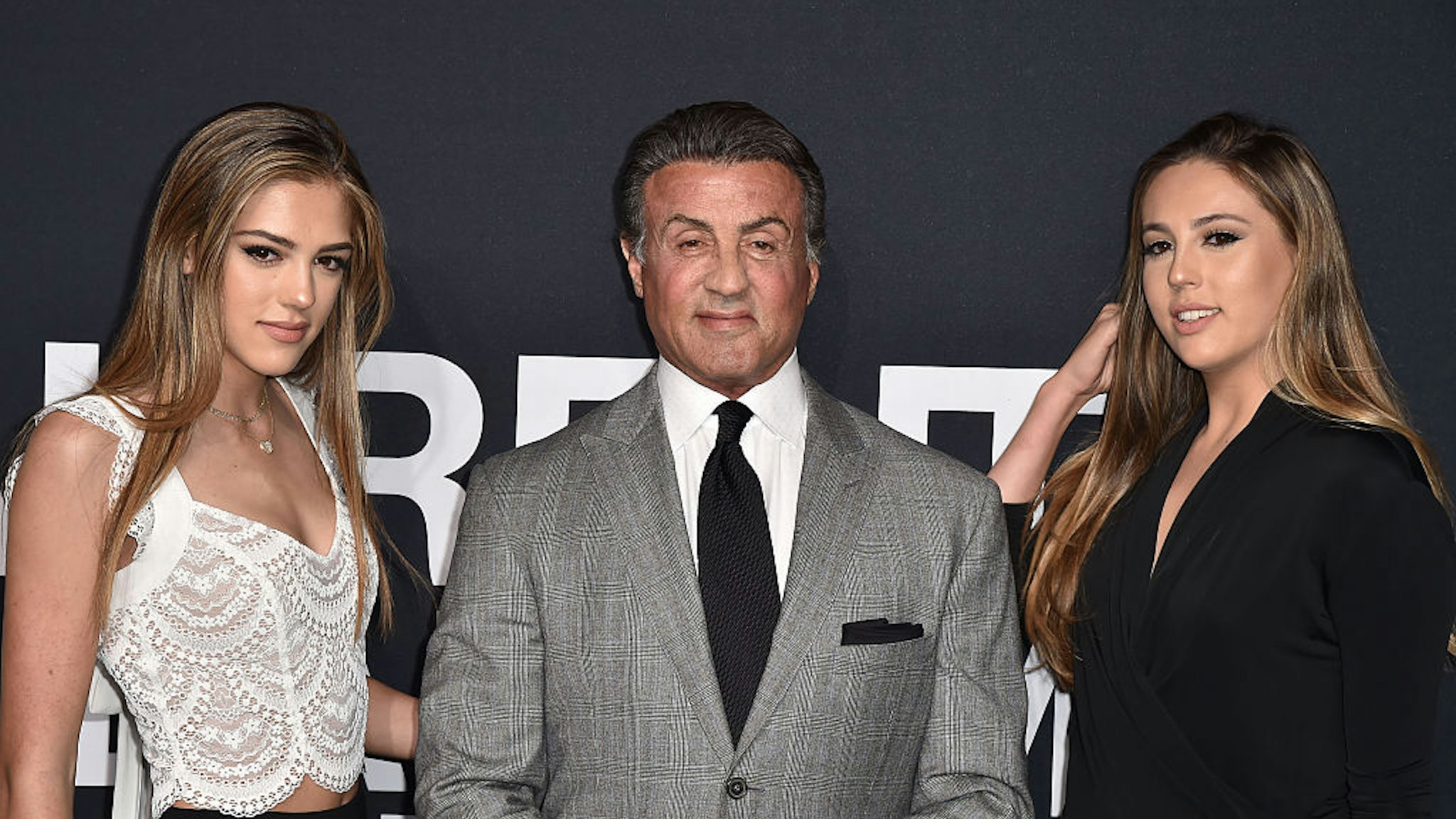LOS ANGELES, CA - FEBRUARY 10: Actor Sylvester Stallone (C) and daughters Sistene Stallone (L) and Sophia Stallone (R) attend Saint Laurent at Hollywood Palladium on February 10, 2016 in Los Angeles, California. (Photo by C Flanigan/WireImage)