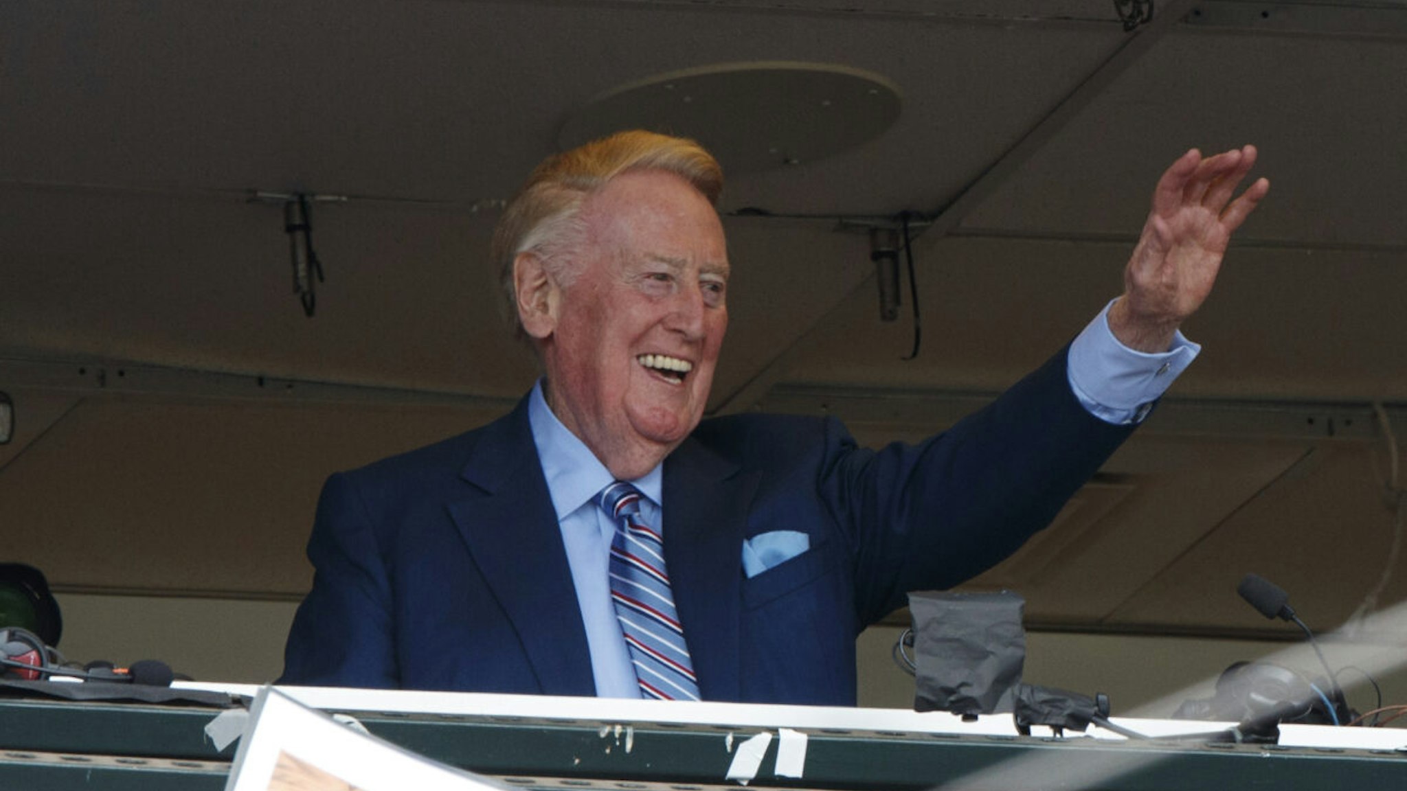 Broadcaster Vin Scully acknowledges fans before the game between the San Francisco Giants and the Los Angeles Dodgers at AT&T Park on October 2, 2016 in San Francisco, California.