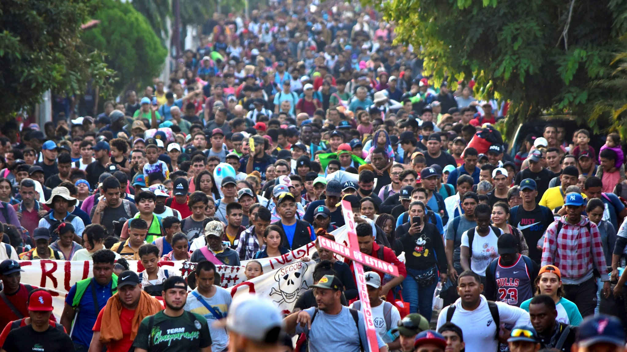 Migrants from Central and South America take part in a caravan attempting to reach the Mexico-US border, while carrying out a viacrucis to protest for the death of 40 migrants in a fire at a detention center in the northern city of Juarez, in Tapachula, Chiapas state, southern Mexico, on April 23, 2023.