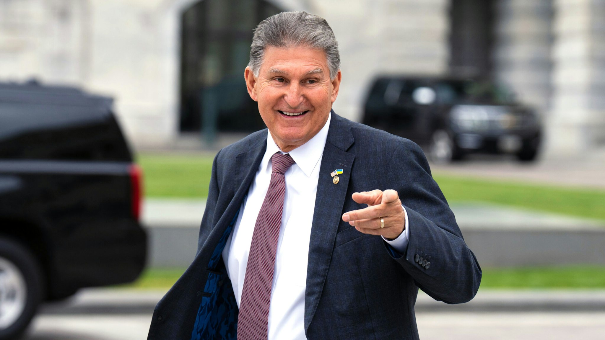 WASHINGTON - MAY 4: Sen. Joe Manchin, D-W. Va., waves to visitors on the Senate steps as he leaves the Capitol after the last vote of the week in Washington on Thurssday, May 4, 2023.