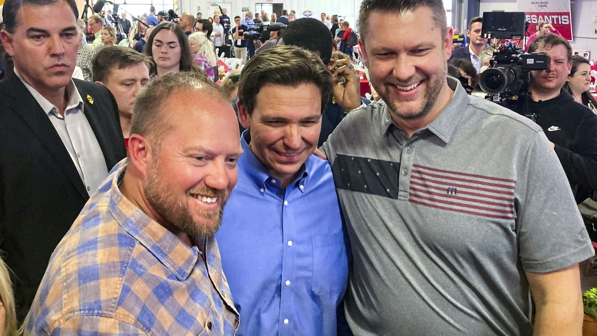 Florida Governor Ron DeSantis (center) poses for photographs after speaking during the Feenstra Family Picnic event in Sioux Center, Iowa on May 13th, 2023.